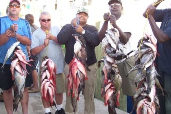 a group of people standing in front of a fish
