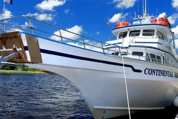 a boat is docked next to a body of water
