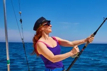 a woman standing next to a body of water
