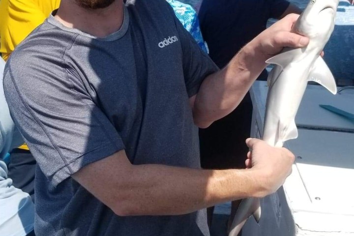 a man holding a fish