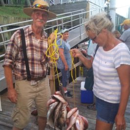a man holding a fish