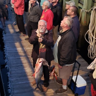 a group of people standing next to a woman