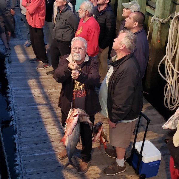 a group of people standing next to a woman