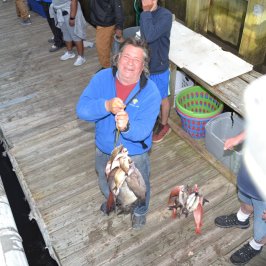 a group of people sitting on a bench with a dog