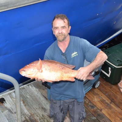 a man standing in front of a boat