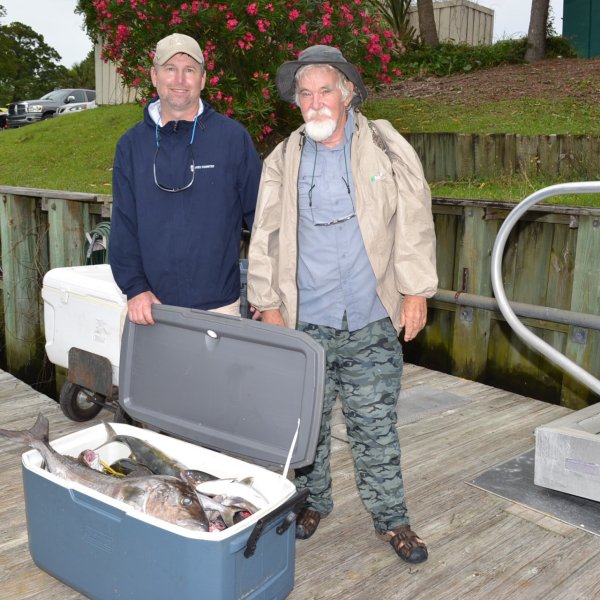 a person standing next to a fence