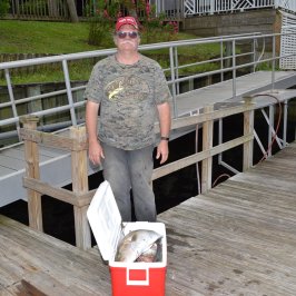 a man standing next to a fence