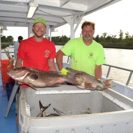a man holding a fish