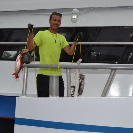 a man standing next to a boat