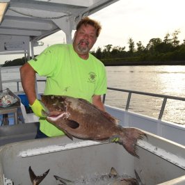 a man standing in front of water