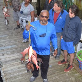a group of people standing on a sidewalk