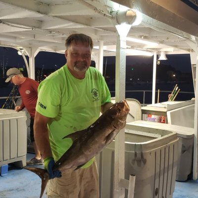 a man standing next to a suitcase