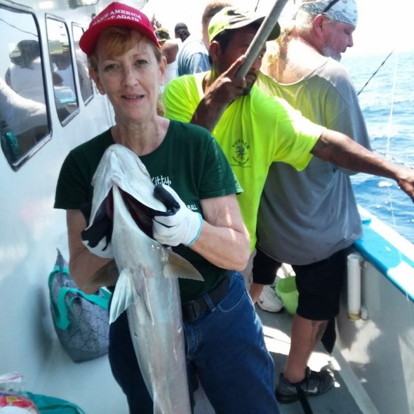 a person holding a fish