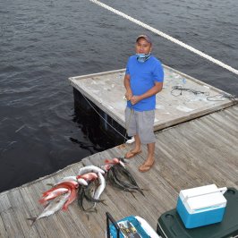 a person standing next to a body of water