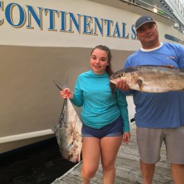 a woman holding a fish