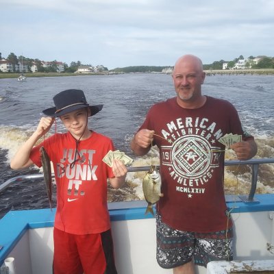a group of people standing next to a body of water