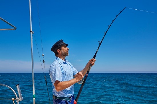 a man standing next to a body of water