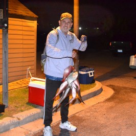 a man and a woman standing in front of a building