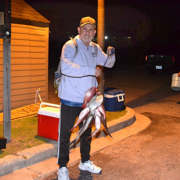 a man and a woman standing in front of a building