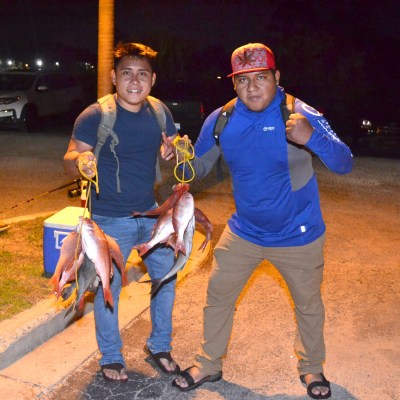 a man and a woman standing on a sidewalk