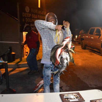 a man and a woman standing next to a car