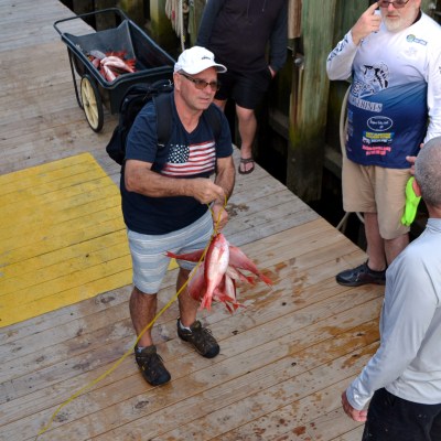 a group of people standing around a bench
