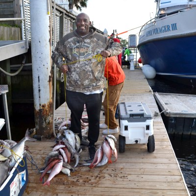 a man standing next to a boat