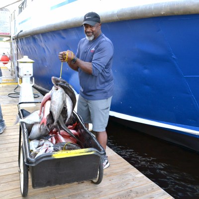 a man standing next to a boat