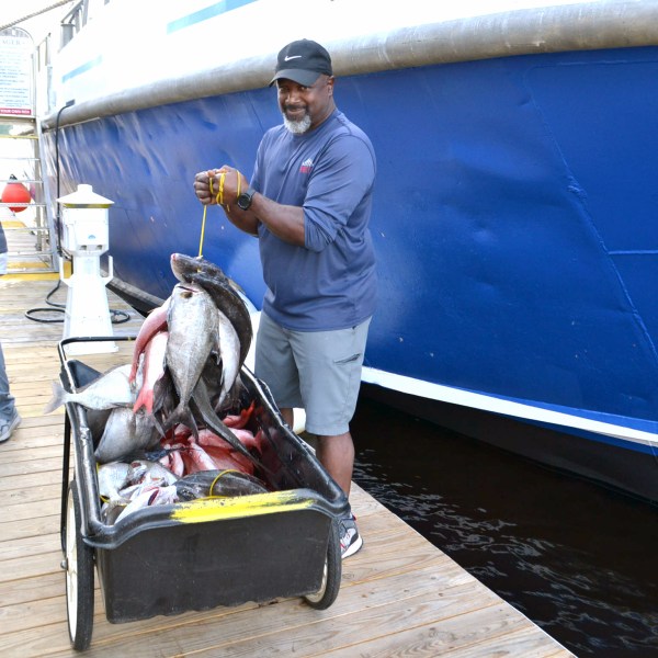 a man standing next to a boat