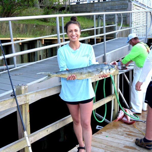 a group of people standing next to a fence