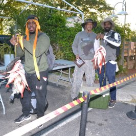 a group of people standing in a parking lot