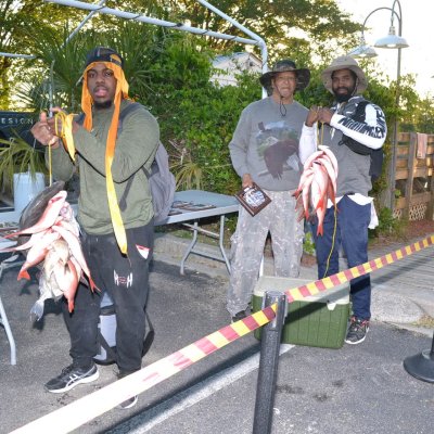 a group of people standing in a parking lot