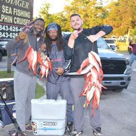 Duke Calhoun et al. standing in a parking lot