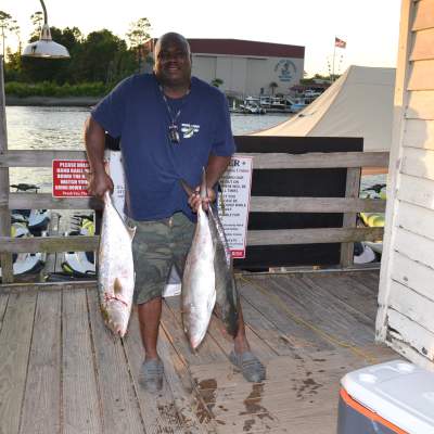 a man holding a fish