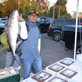 a man standing on top of a car posing for the camera