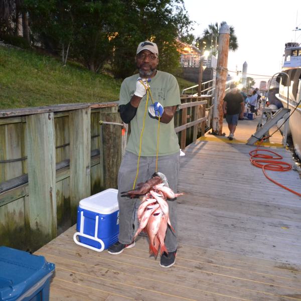 a man standing next to a boat