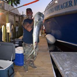 a man standing next to a boat
