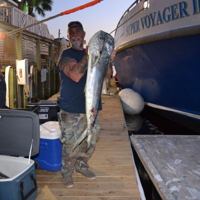 a man standing next to a boat