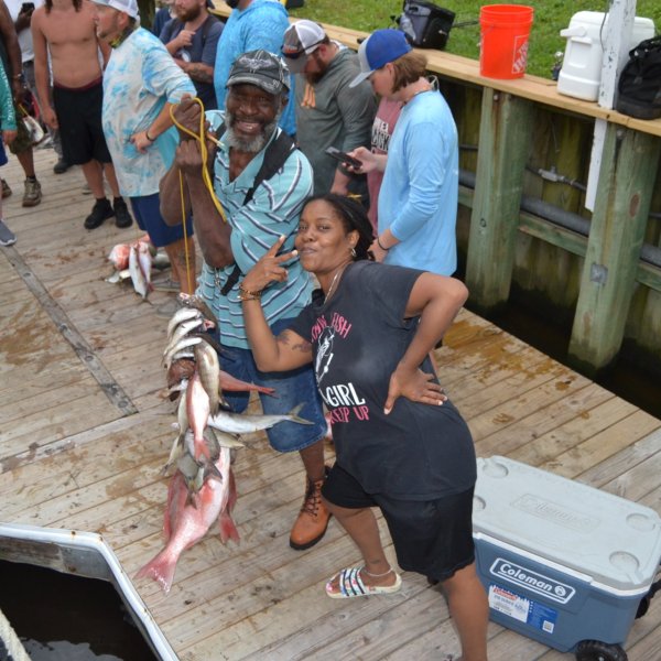a group of people standing on top of a wooden fence