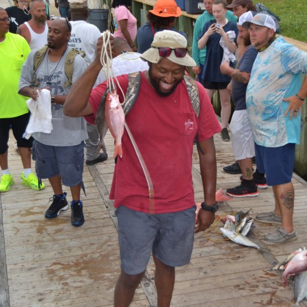 Anthony Mackie et al. standing in front of a crowd