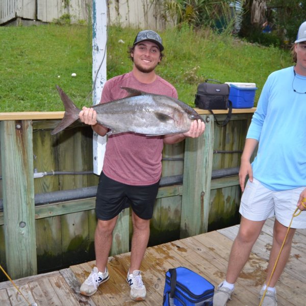 a man holding a fish