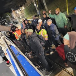 a group of people standing on a snow board