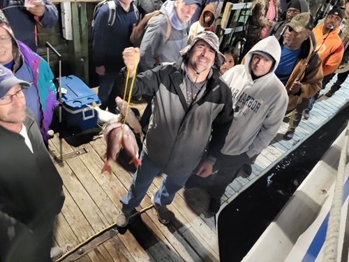 Deep sea fishing in Myrtle Beach SC a group of people standing in front of a crowd