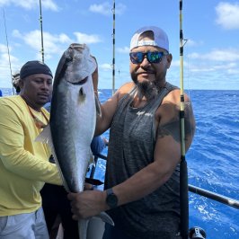 a person holding a fish on a boat