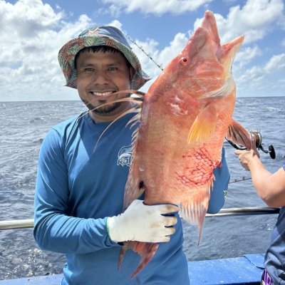 a person holding a fish in the water