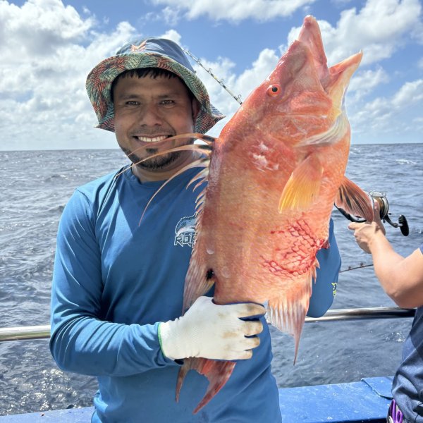 a person holding a fish in the water