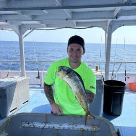 a man sitting on a boat in the water