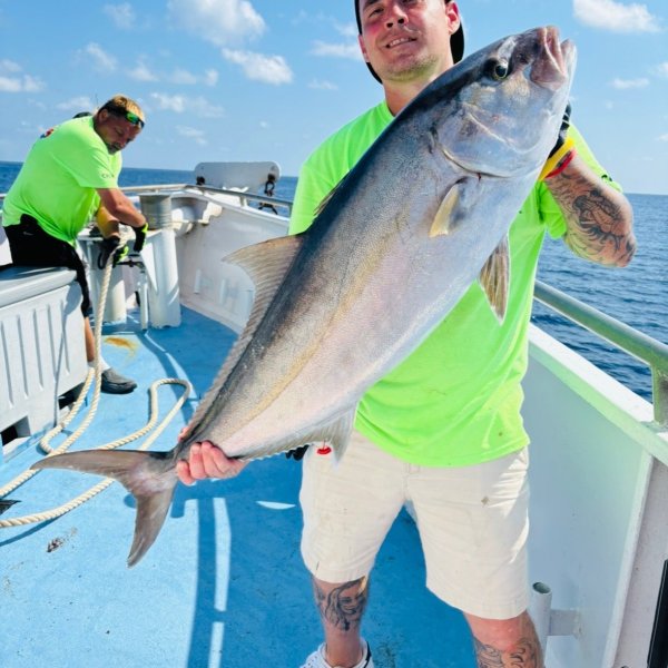 a man holding a fish