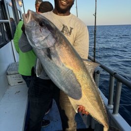 a man holding a fish in the water