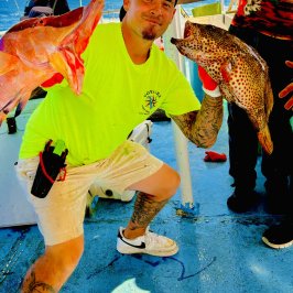a man holding a hot air balloon in the sky
